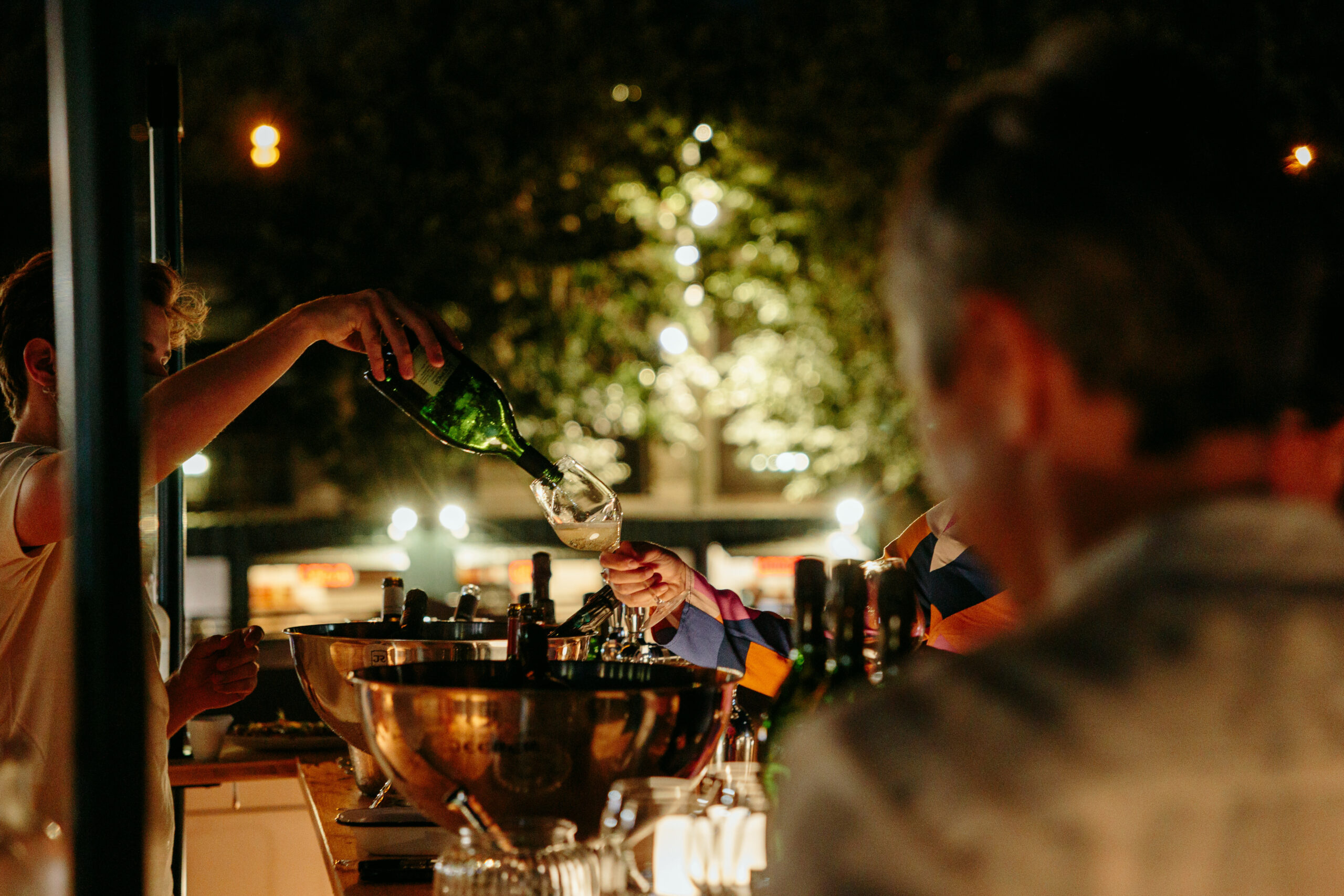 Pouring into glasses at a cocktail, in Paris. High quality photo